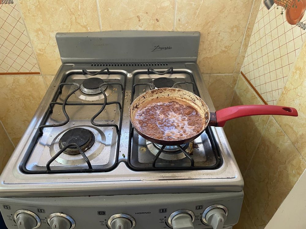 Cacao warming in a small pan with a splash of water